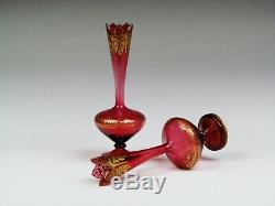 A pair of late 19th century Bohemian cranberry glass vases decorated with gilded